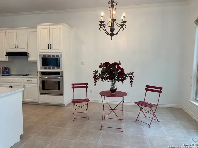 a view of kitchen with furniture and chandelier