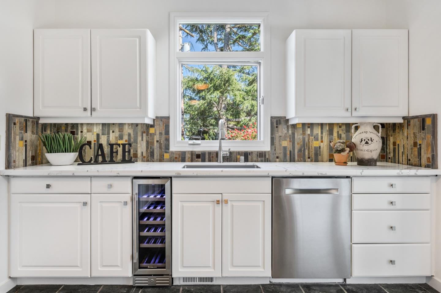 541 Nevada Avenue San Mateo, CA 94402 - Photo 42 of 100 a kitchen with stainless steel appliances white cabinets and a window