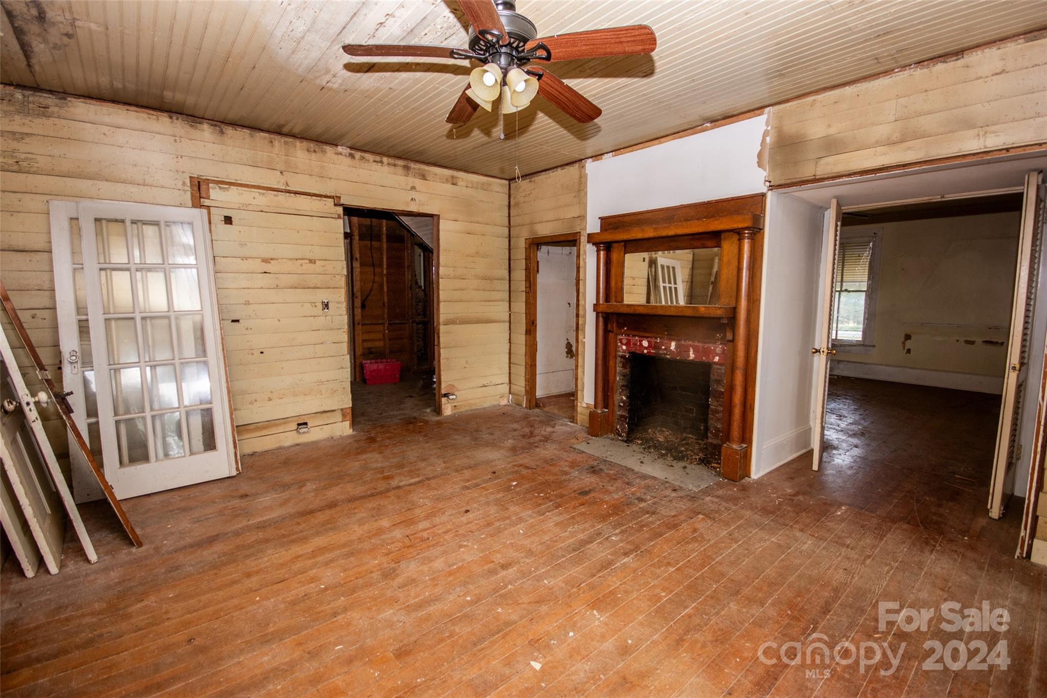 431 Friendship Road Olin, NC 28660 - Photo 16 of 44 a view of a livingroom with an empty space and a ceiling fan