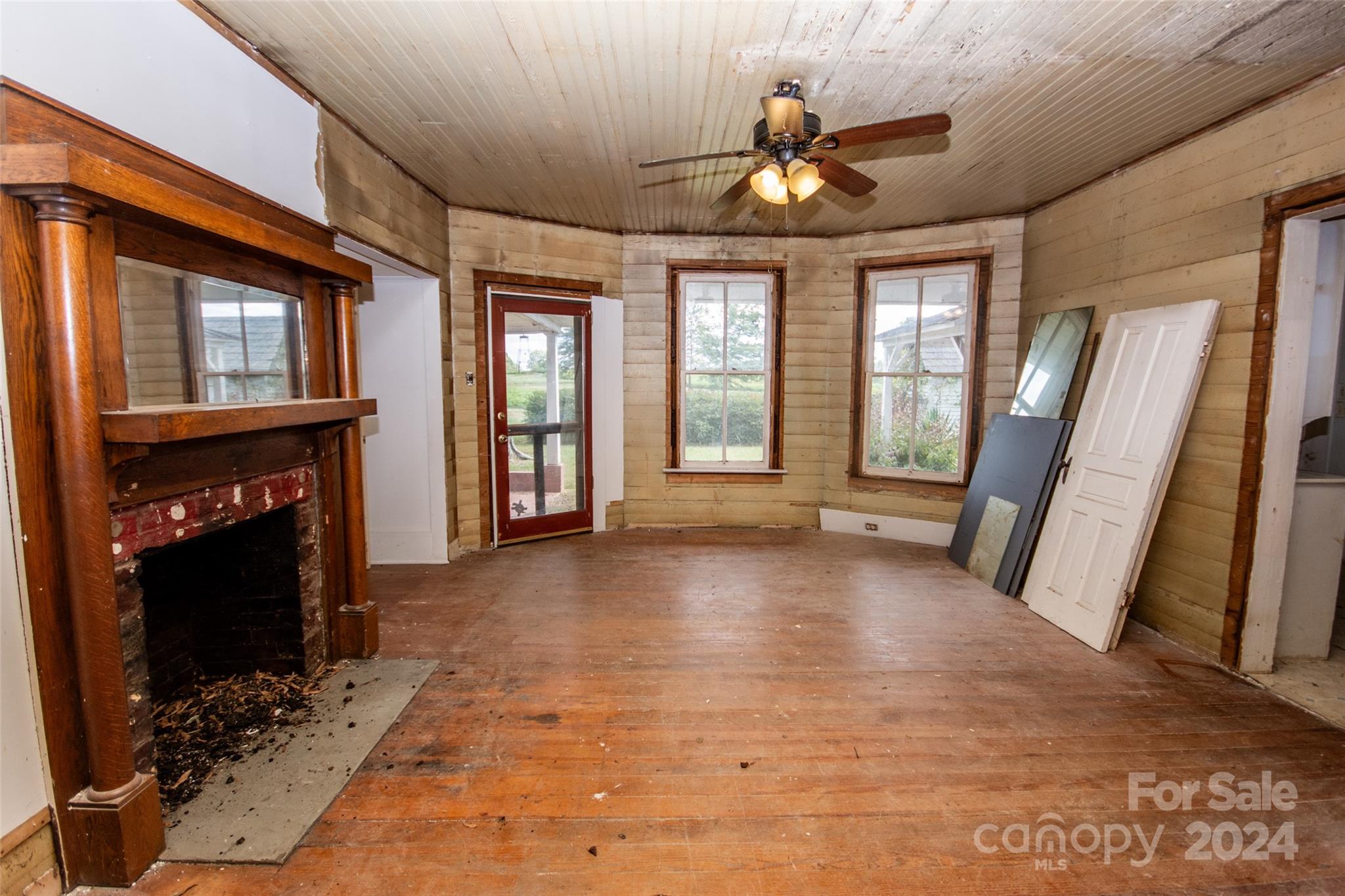 431 Friendship Road Olin, NC 28660 - Photo 18 of 44 a view of an empty room with a fireplace and a window