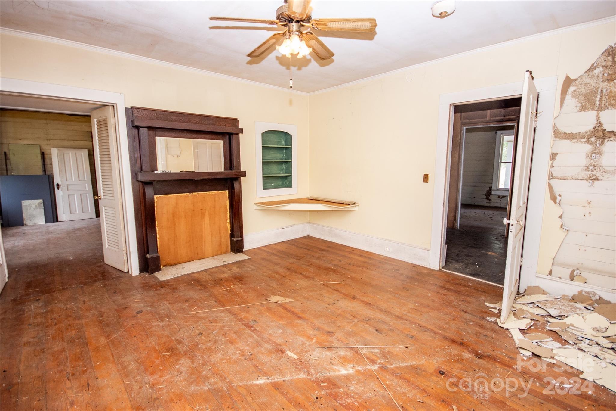 431 Friendship Road Olin, NC 28660 - Photo 20 of 44 a view of a livingroom with a chandelier fan and a kitchen