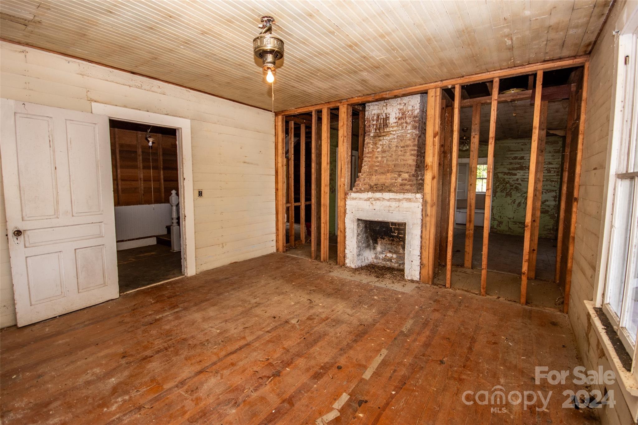 431 Friendship Road Olin, NC 28660 - Photo 22 of 44 a view of an empty room with a fireplace and a window
