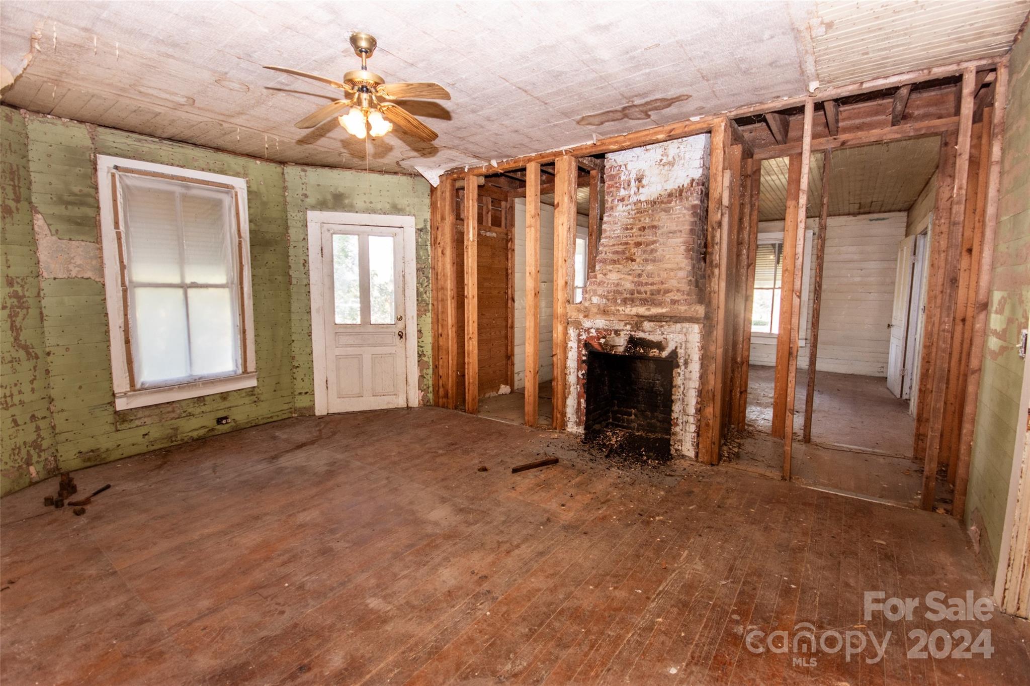 431 Friendship Road Olin, NC 28660 - Photo 23 of 44 a view of an empty room with a fireplace and a window
