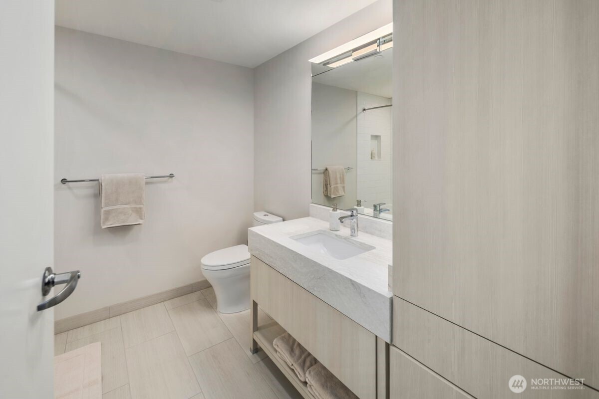 1250 Alki Avenue Southwest, Unit 3C Seattle, WA 98116 - Photo 14 of 31 a bathroom with a sink toilet and a mirror