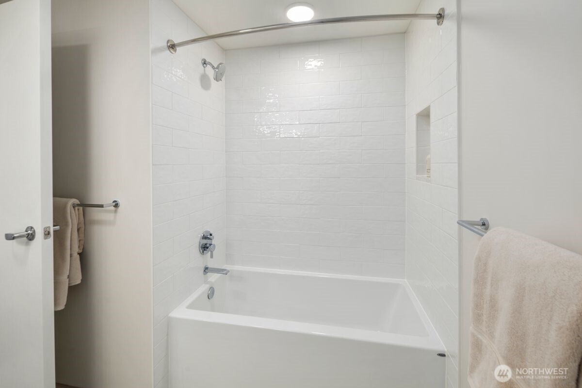 1250 Alki Avenue Southwest, Unit 3C Seattle, WA 98116 - Photo 15 of 31 a white bath tub with a shower