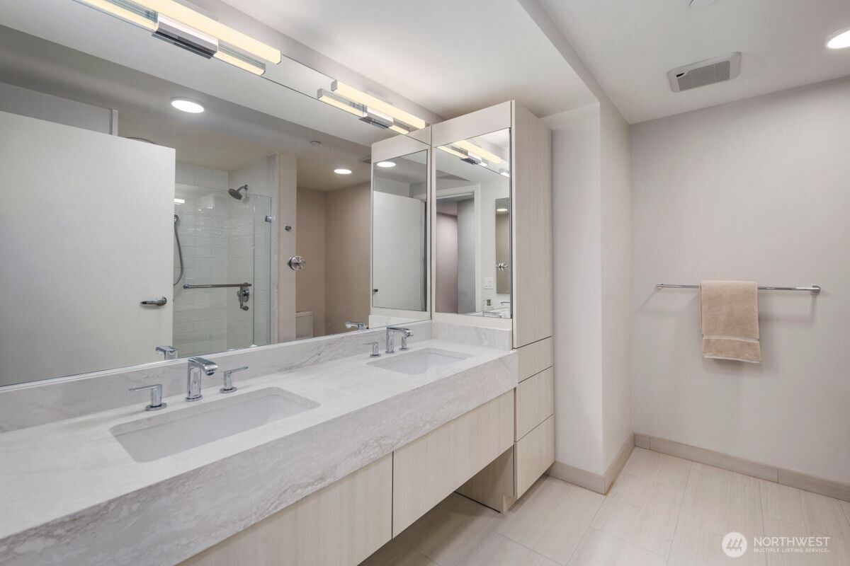 1250 Alki Avenue Southwest, Unit 3C Seattle, WA 98116 - Photo 17 of 31 a bathroom with a double vanity sink mirror and double