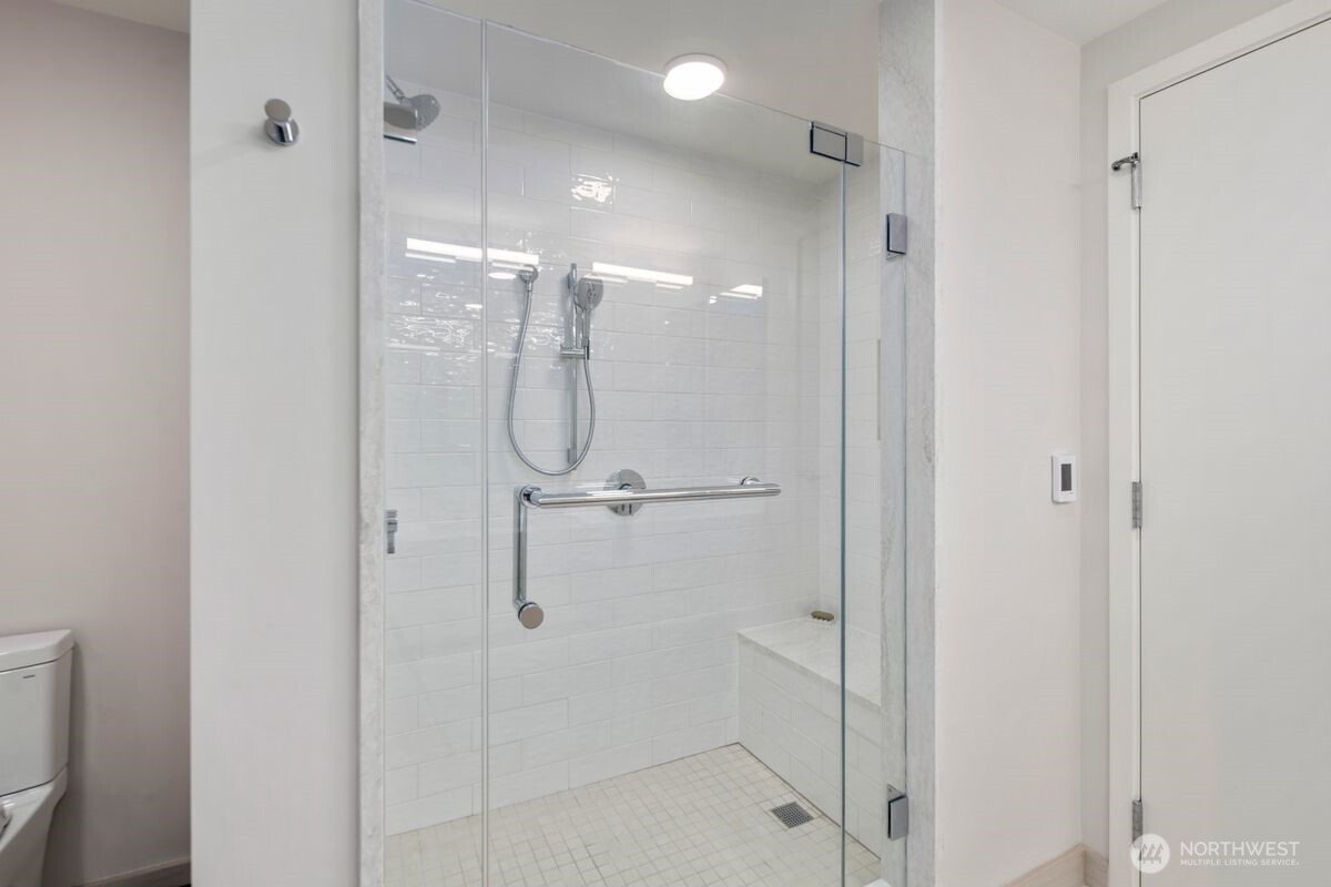 1250 Alki Avenue Southwest, Unit 3C Seattle, WA 98116 - Photo 18 of 31 a bathroom with a glass shower door