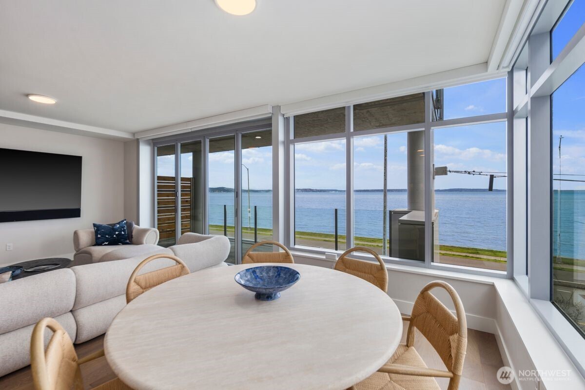 1250 Alki Avenue Southwest, Unit 3C Seattle, WA 98116 - Photo 4 of 31 a living room with furniture and a large window