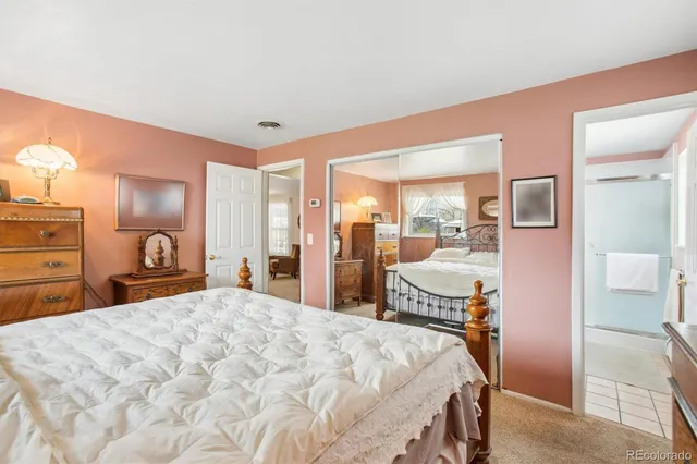 a bedroom with a large bed and a dresser