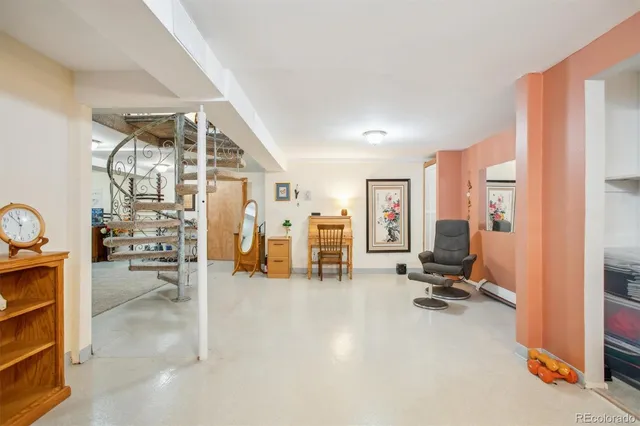 a view of a livingroom with furniture and an empty room