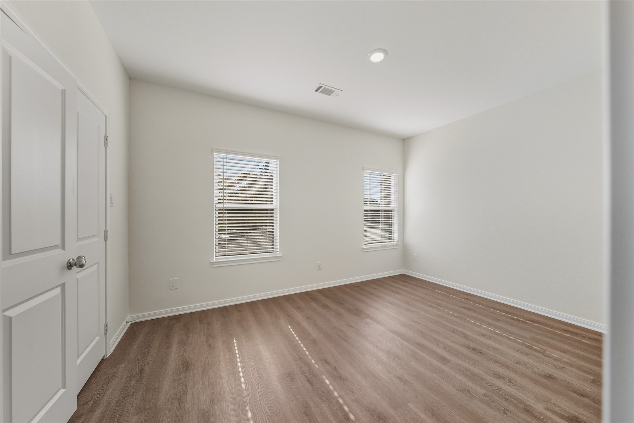 708 West Dallas Street Conroe, TX 77301 - Photo 16 of 19 a view of an empty room with wooden floor and a window
