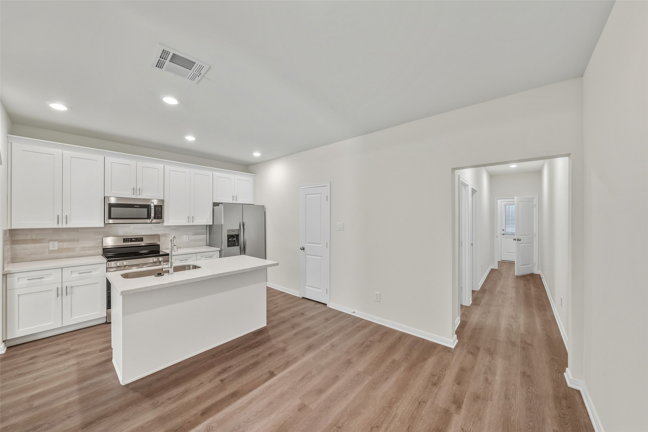 708 West Dallas Street Conroe, TX 77301 - Photo 9 of 19 a kitchen with stainless steel appliances a stove top oven a sink and a refrigerator