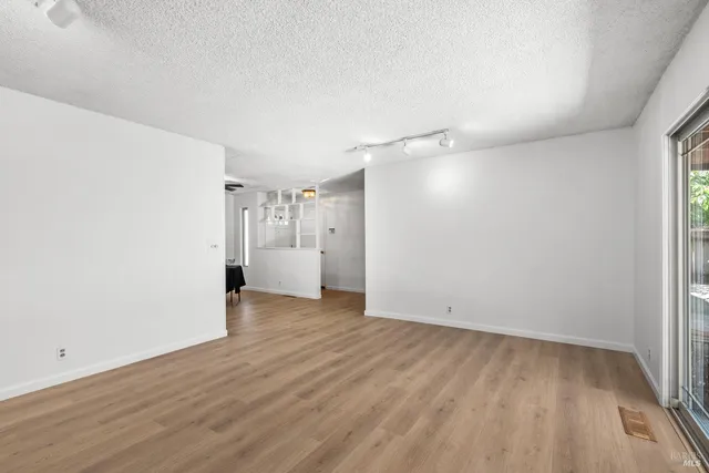 a view of a hallway with wooden floor