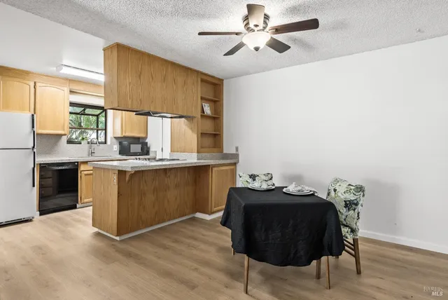 a view of a workspace with furniture and wooden floor