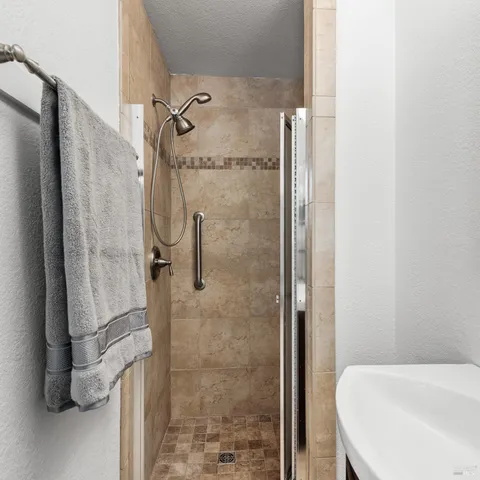 a view of backyard with wooden fence and large trees