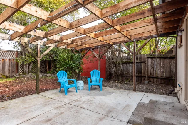 a view of a house with a yard and tree