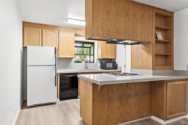 a kitchen with a sink and a refrigerator