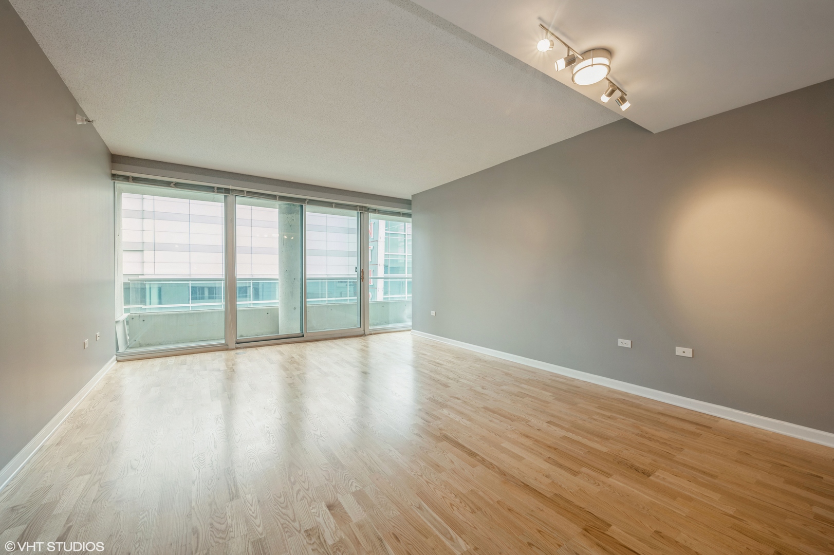 1720 Maple Avenue, Unit 406 Evanston, IL 60201 - Photo 3 of 13 wooden floor in an empty room with a window