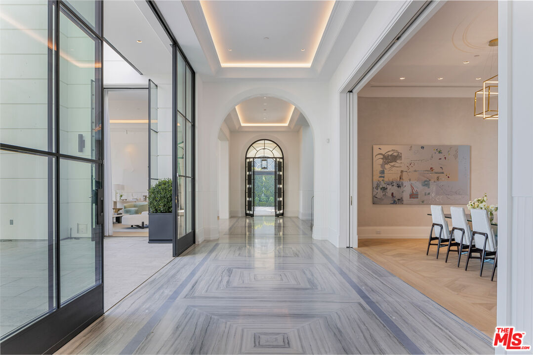 1898 Rising Glen Road Los Angeles, CA 90069 - Photo 9 of 38 a view of a hallway with wooden floor and furniture