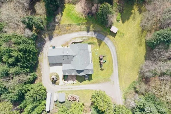 an aerial view of a house with a swimming pool