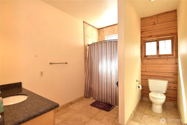a view of a room with a wooden floor and a window