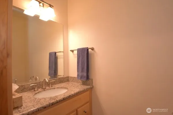 a kitchen with granite countertop a sink and cabinets