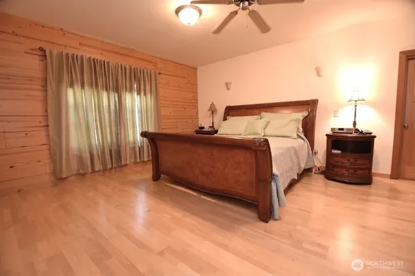 a bedroom with a large bed and a chandelier