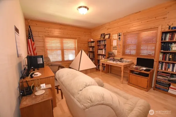 a bedroom with furniture and a flat screen tv