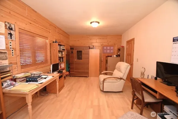 a dining room with furniture and a floor to ceiling window