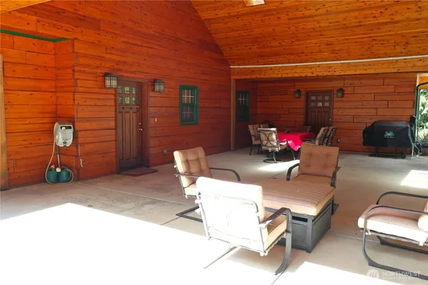 a outdoor living space with patio furniture and a fireplace