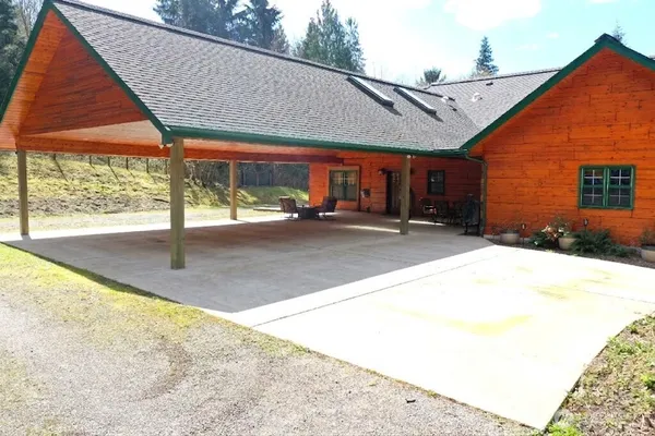 a backyard of a house with yard and outdoor seating