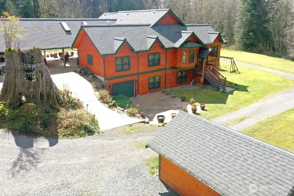 an aerial view of a house with swimming pool and patio