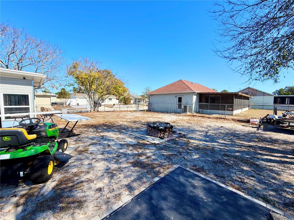9840 Crofton Lane Port Richey, FL 34668 - Photo 11 of 12 a front view of a house with a garden and yard