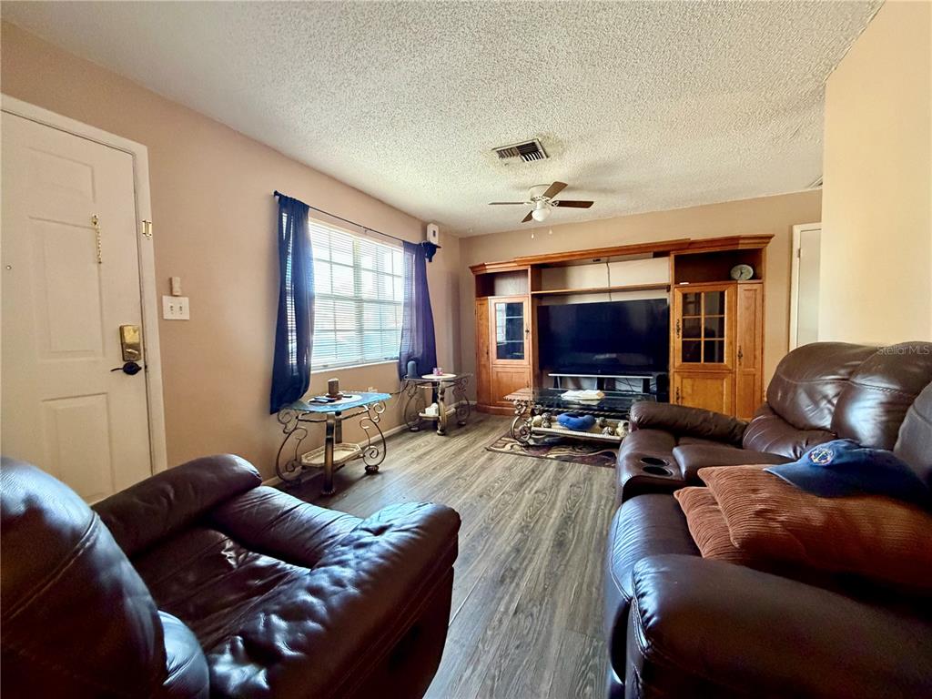 9840 Crofton Lane Port Richey, FL 34668 - Photo 2 of 12 a living room with furniture and a flat screen tv