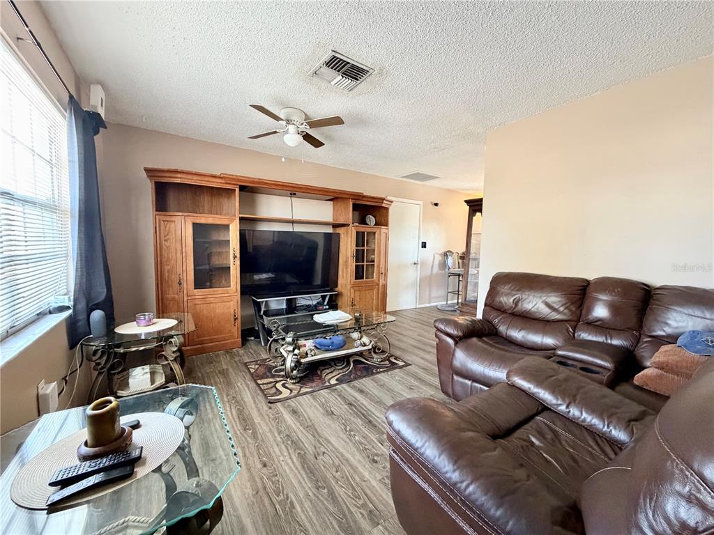 9840 Crofton Lane Port Richey, FL 34668 - Photo 3 of 12 a living room with furniture and a flat screen tv