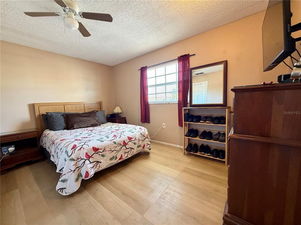 9840 Crofton Lane Port Richey, FL 34668 - Photo 8 of 12 a bedroom with a bed and a couch