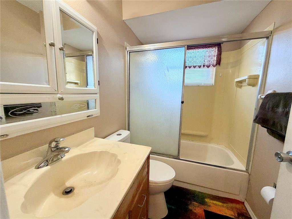 9840 Crofton Lane Port Richey, FL 34668 - Photo 9 of 12 a bathroom with a sink toilet and shower