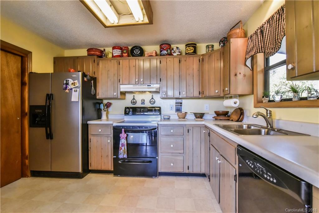 286 Pioneer Ridge Road Canton, NC 28716 - Photo 22 of 33 a kitchen with stainless steel appliances granite countertop a refrigerator a sink and dishwasher a stove top oven