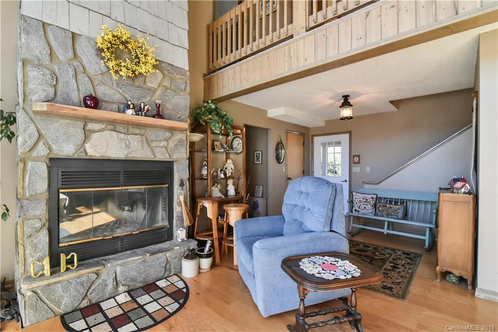 286 Pioneer Ridge Road Canton, NC 28716 - Photo 27 of 33 a living room with furniture and a fireplace