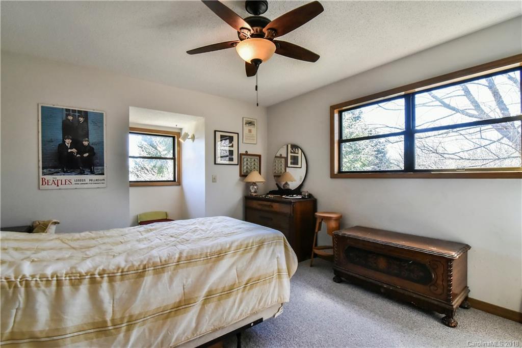 286 Pioneer Ridge Road Canton, NC 28716 - Photo 28 of 33 a bedroom with a bed and a window
