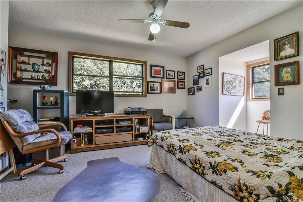 286 Pioneer Ridge Road Canton, NC 28716 - Photo 32 of 33 a bedroom with a bed and a flat screen tv