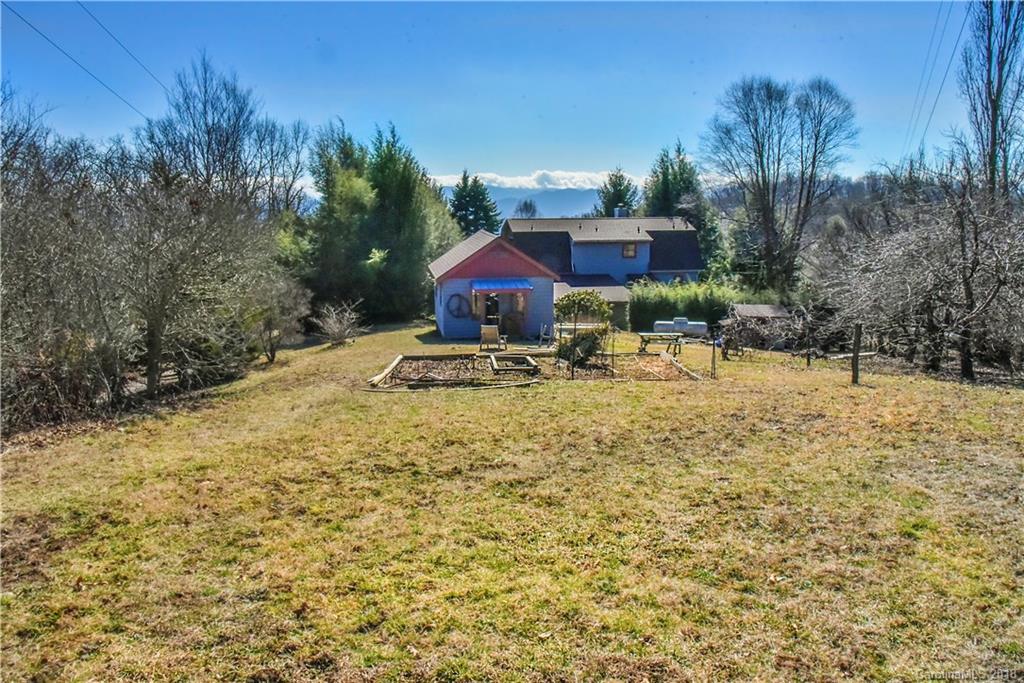 286 Pioneer Ridge Road Canton, NC 28716 - Photo 5 of 33 a swimming pool with outdoor seating and yard
