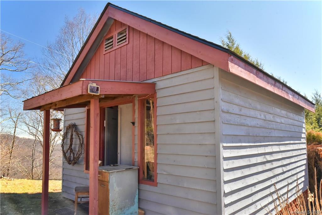 286 Pioneer Ridge Road Canton, NC 28716 - Photo 7 of 33 a view of a house with a small cabin