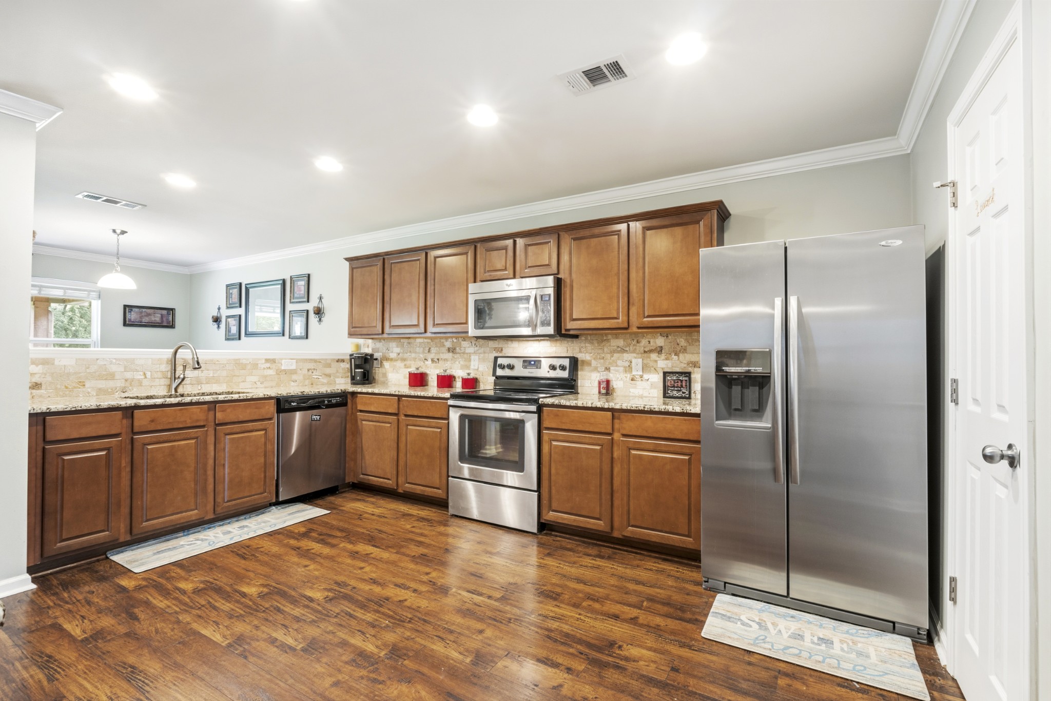 1011 Benwick Road Hendersonville, TN 37075 - Photo 17 of 60 a kitchen with stainless steel appliances granite countertop a refrigerator a sink dishwasher a stove top oven a kitchen island and cabinets with wooden floor
