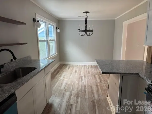 a view of a kitchen from a hallway