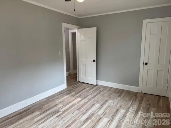 a view of an empty room with wooden floor