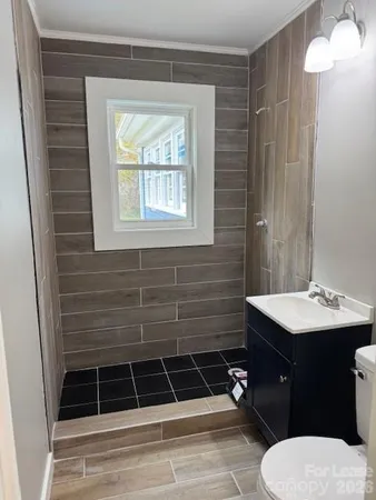 a bathroom with a sink toilet and shower