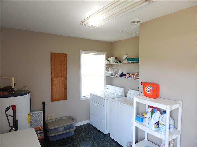 25517 Sweet Springs Road Elkmont, AL 35620 - Photo 9 of 18 a bathroom with a sink a vanity and a window