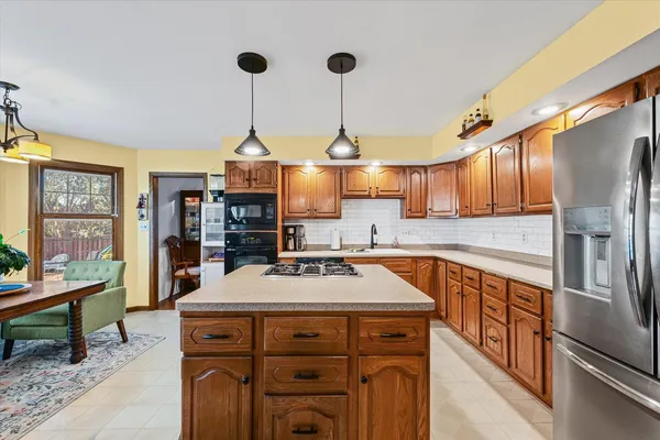 a kitchen with stainless steel appliances a stove refrigerator sink and cabinets