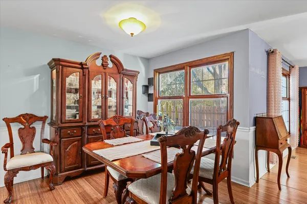 a view of a dining room with furniture and a large window